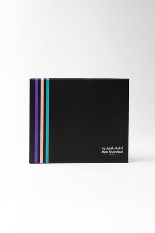 Black cosmetic palette with colorful stripes on a white background by Atyab Al Marshoud.