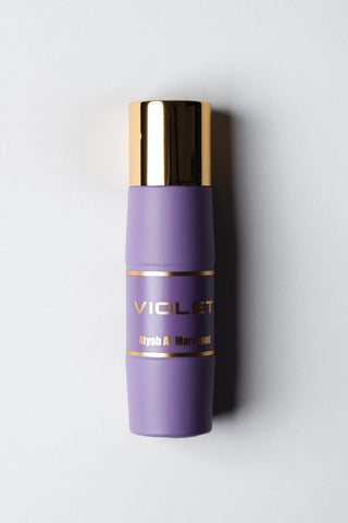 Voilet Perfume bottle with gold cap on a white background by Atyab Al Marshoud.